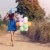 Woman walking away with balloons