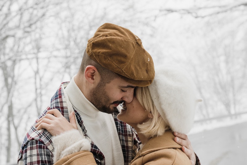 couple kissing in winter scene