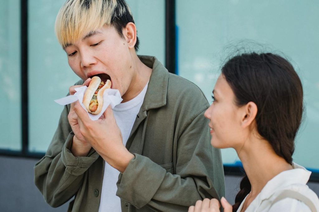 a man eating a hot dog